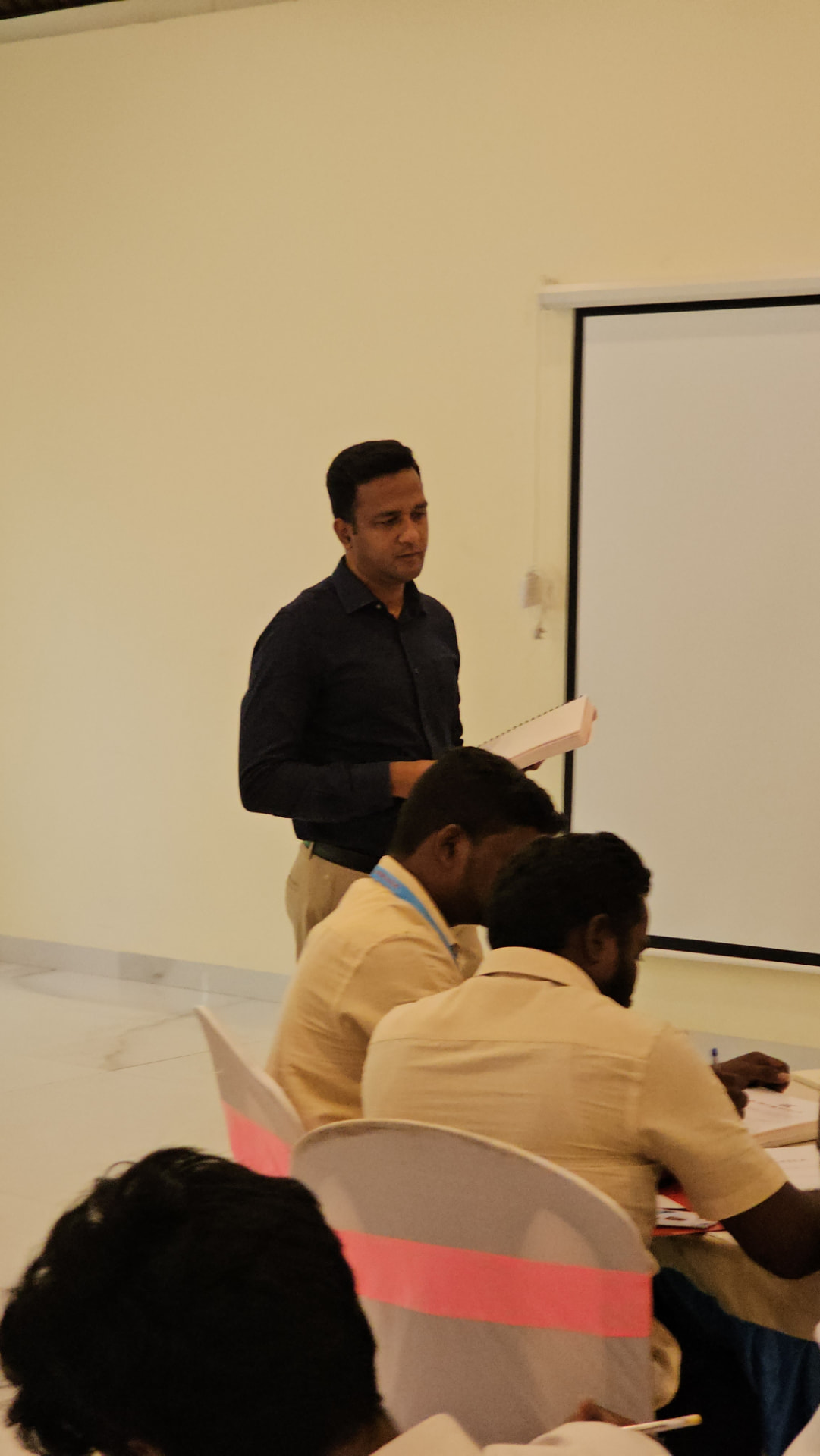 Coach Dhejo reviewing growth plans with business owners during a session